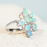 blue and green crystal opal ring in white gold with three diamonds