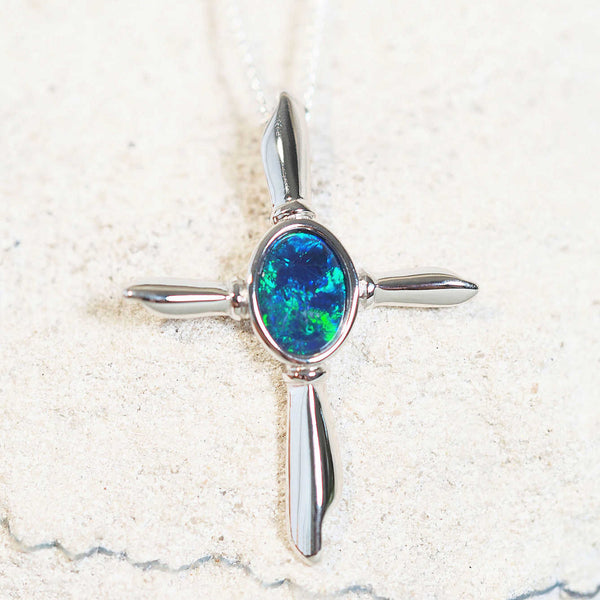 cross opal pendant set with a green and blue triplet opal stone