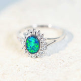 shimmery green and blue white gold ring with diamonds