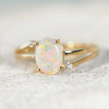 floral patterned opal set into a 14ct yellow gold ring with diamonds