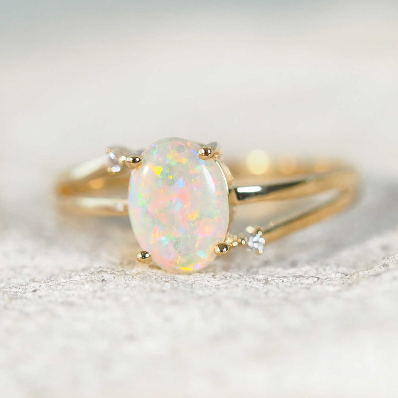 floral patterned opal set into a 14ct yellow gold ring with diamonds