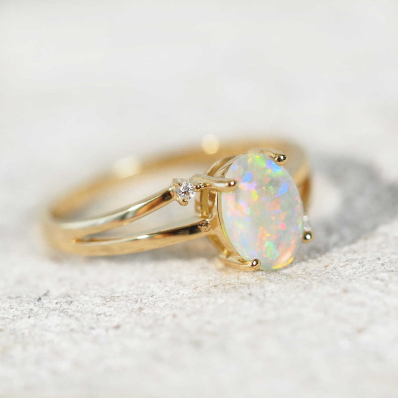 bright crystal opal gold ring set with two diamonds