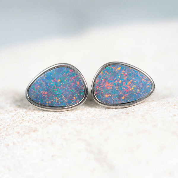 Adyiah sterling silver stud opal earrings featuring vibrant triangular Australian doublet opals with pinfire pattern, bezel set for a secure and elegant look.