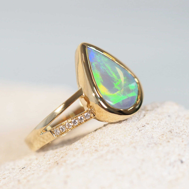 gold opal ring set with a blue, green and yellow coloured natural Australian opal