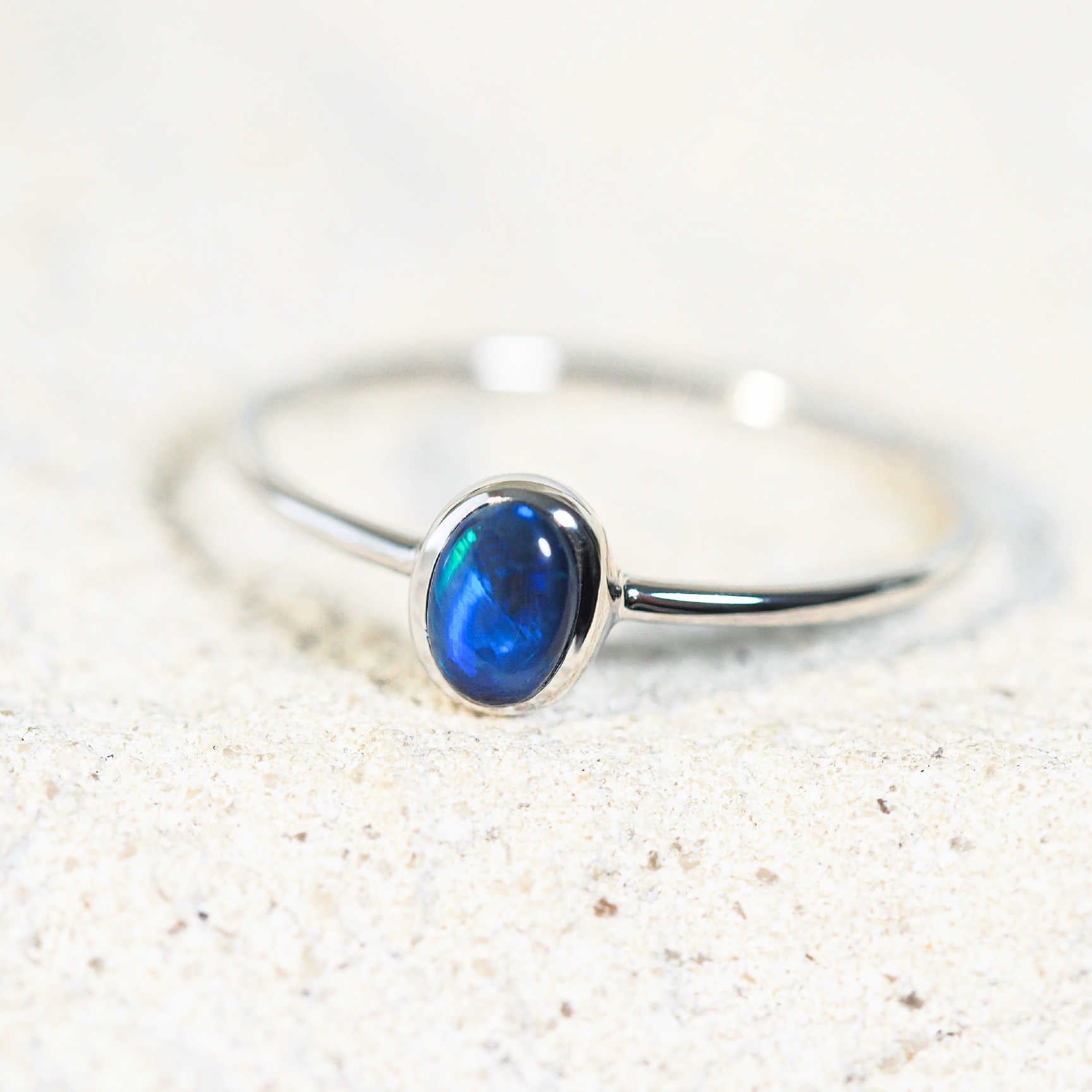 blue opal ring featuring a Lightning Ridge solid black opal