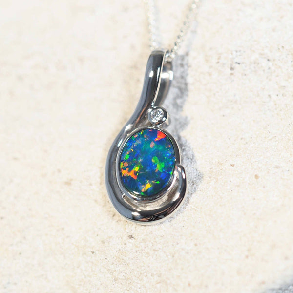 Alaina opal pendant in 14ct white gold featuring a multi-coloured oval Australian doublet opal and one sparkling white diamond.