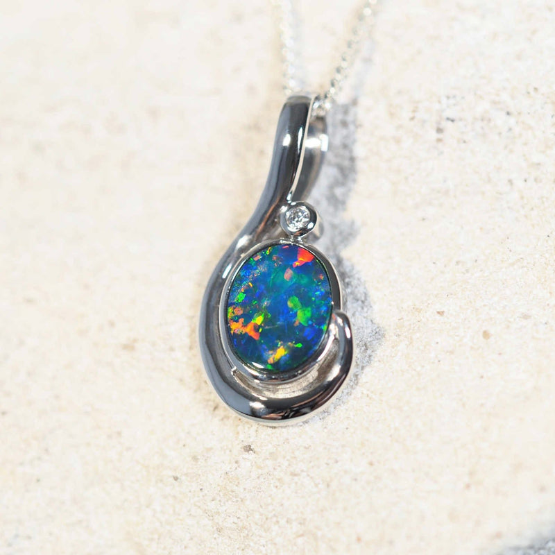 Alaina opal pendant in 14ct white gold featuring a multi-coloured oval Australian doublet opal and one sparkling white diamond.