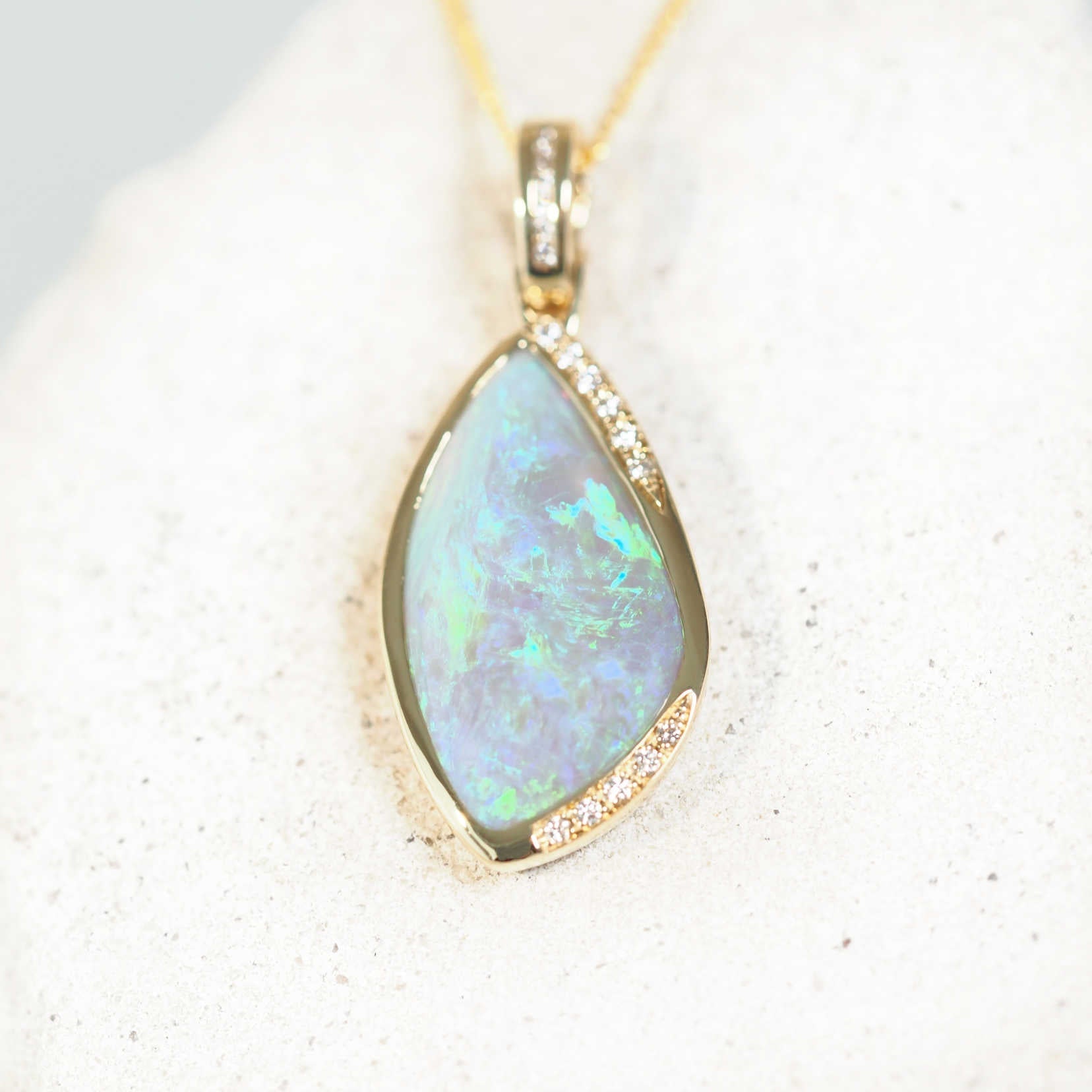 green crystal opal pendant set in 14ct yellow gold with diamonds