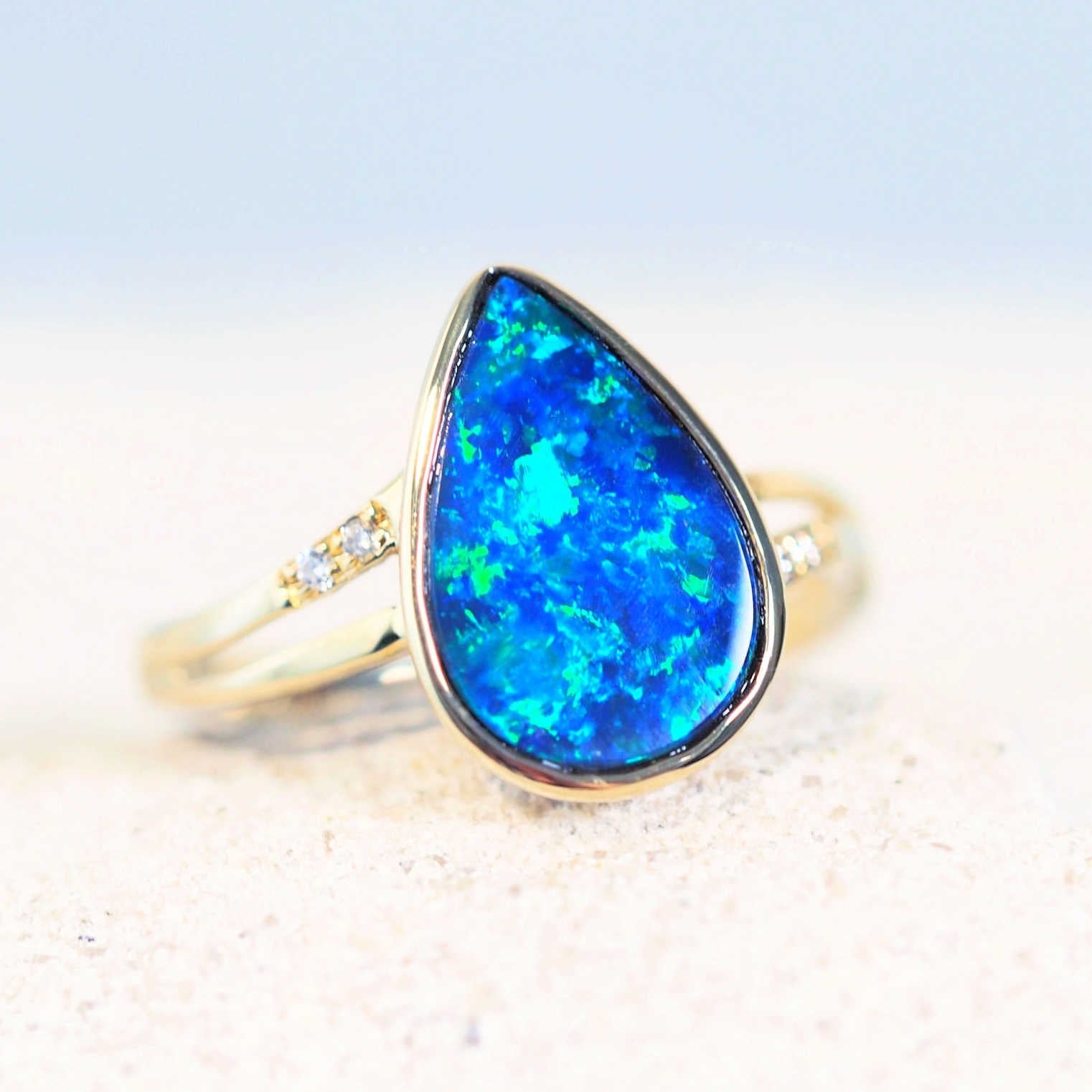 blue and green opal ring in gold with diamonds