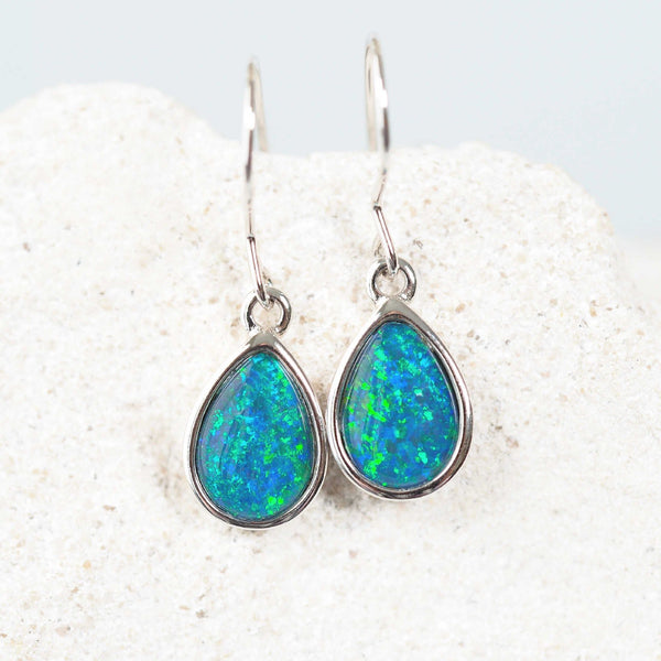 teardrop shaped silver earrings set with opals in a blue and green colour