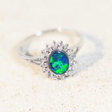 green and blue opal ring set in white gold surrounded by 16 diamonds