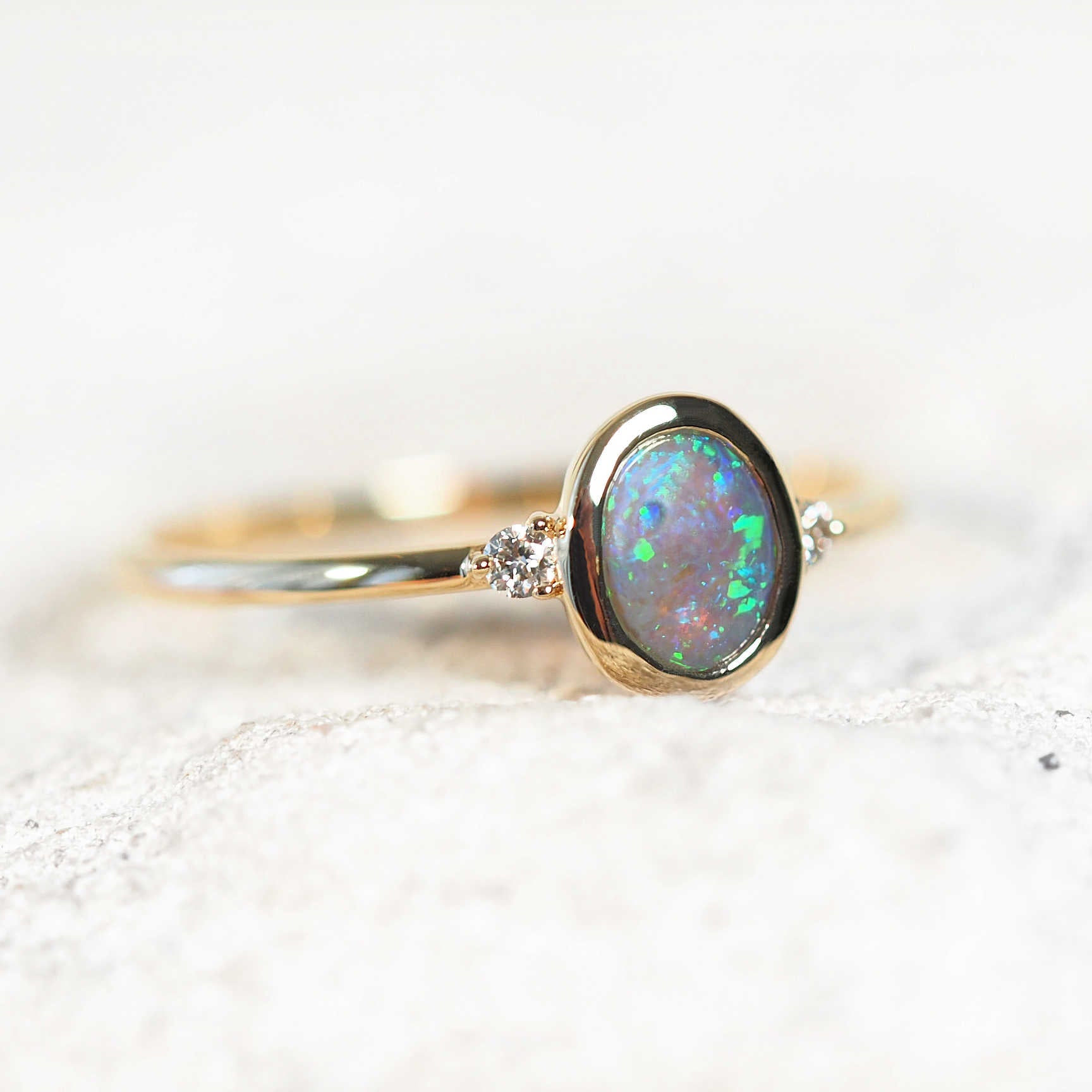 crystal black opal ring with green and blue twinkles
