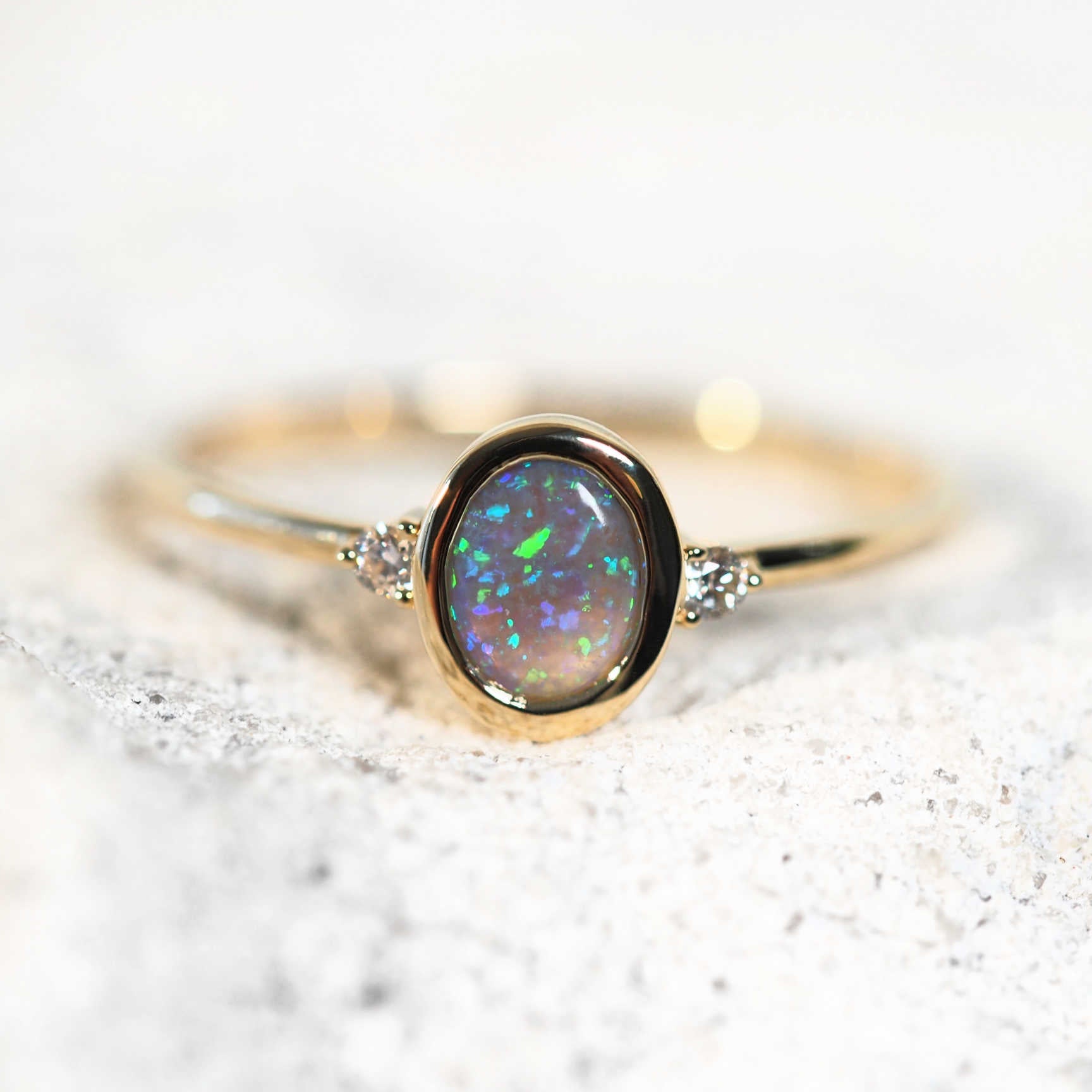 black crystal opal ring set in 14ct yellow gold