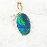 14ct yellow gold opal pendant featuring a green and blue Australian doublet opal and white diamonds.