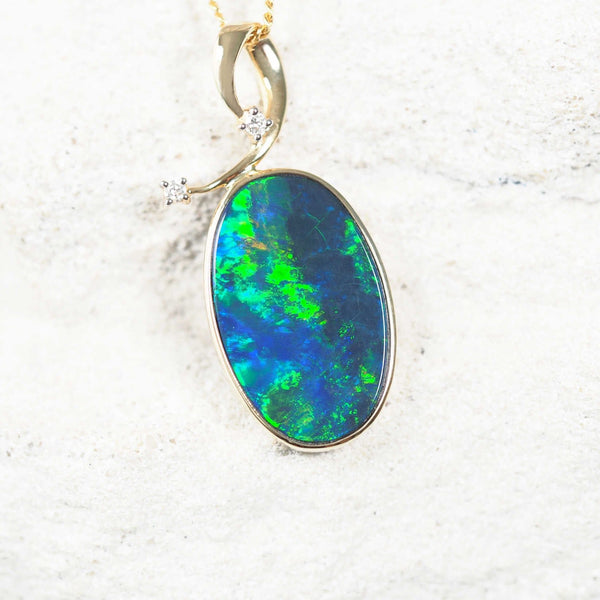 14ct yellow gold opal pendant featuring a green and blue Australian doublet opal and white diamonds.