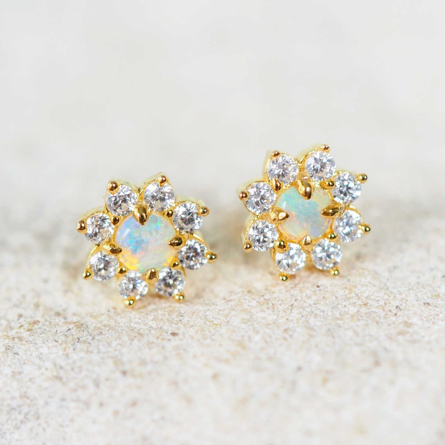 Celestia opal earrings in gold-plated silver featuring vibrant blue and green Australian solid crystal opals surrounded by eight sparkling diamantés