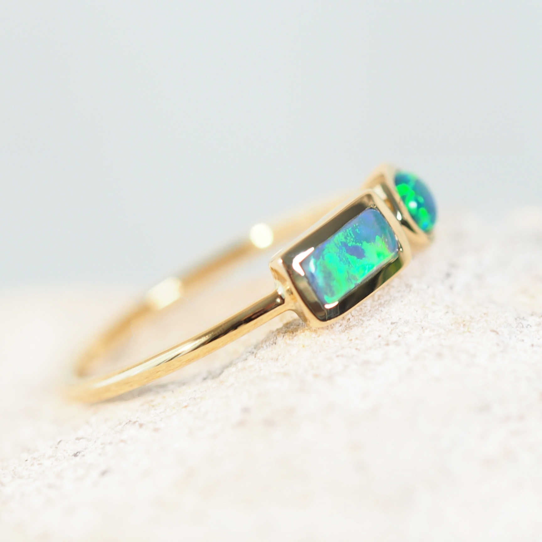 black opal ring set in yellow gold with a lightning ridge green opal