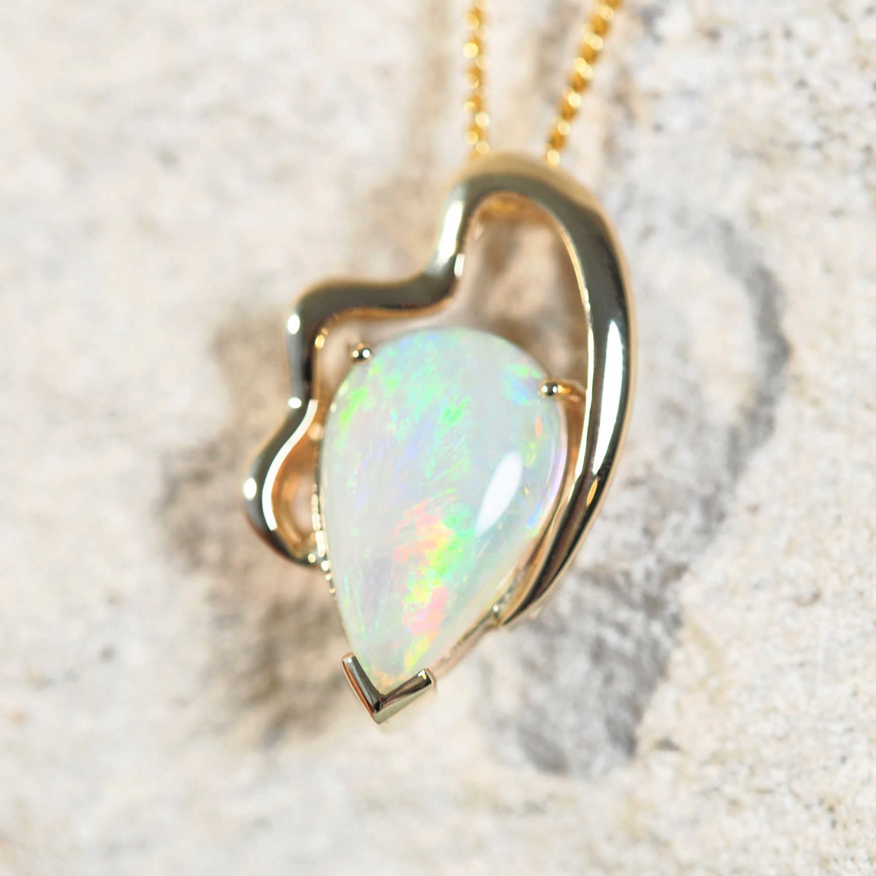 crystal opal pendant set in 14ct yellow gold