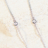 bezel set diamonds set into a white gold chain