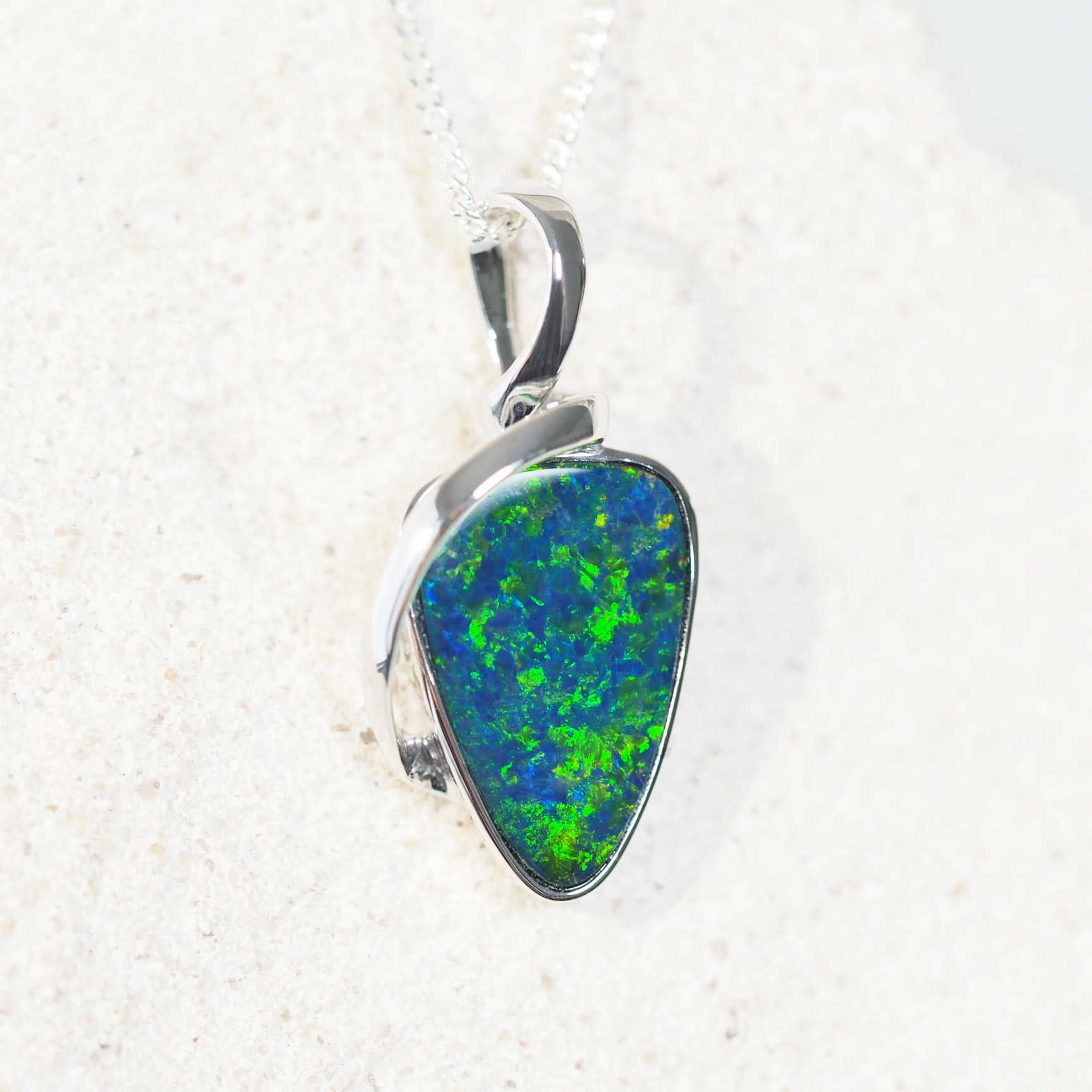 teardrop shape opal doublet white gold necklace featuring a blue and green opal