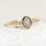 black opal ring featuring a colourful floral pattern