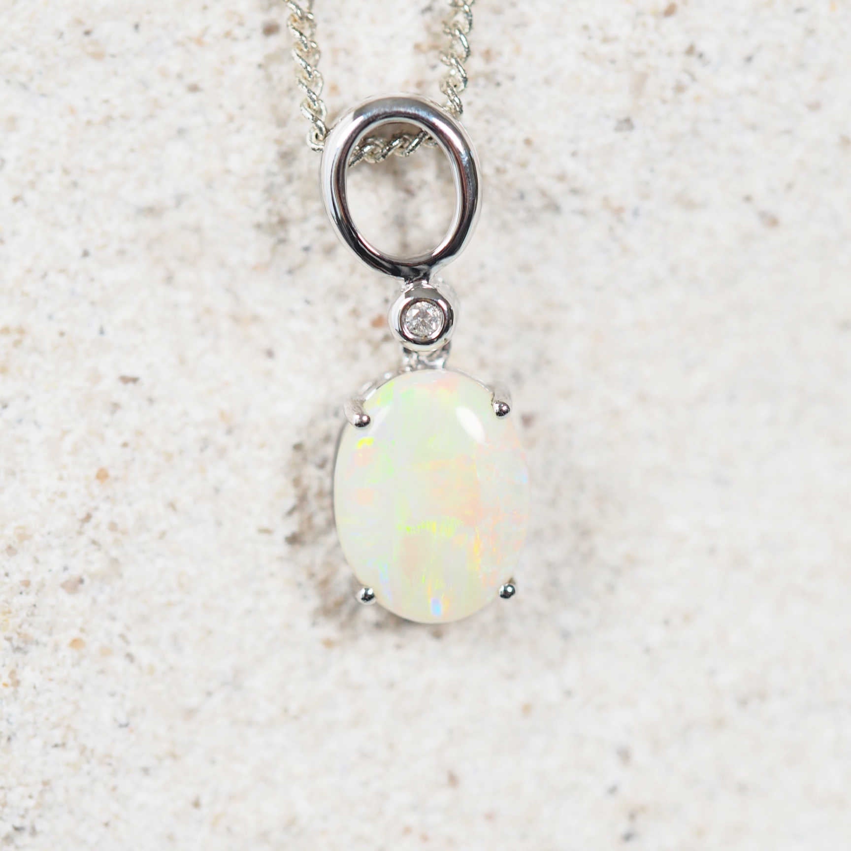 white gold crystal opal pendant featuring a colourful south australian opal stone