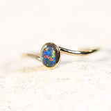 gold ring set with a solid black opal