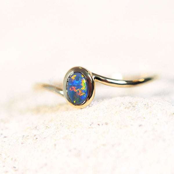 gold ring set with a solid black opal