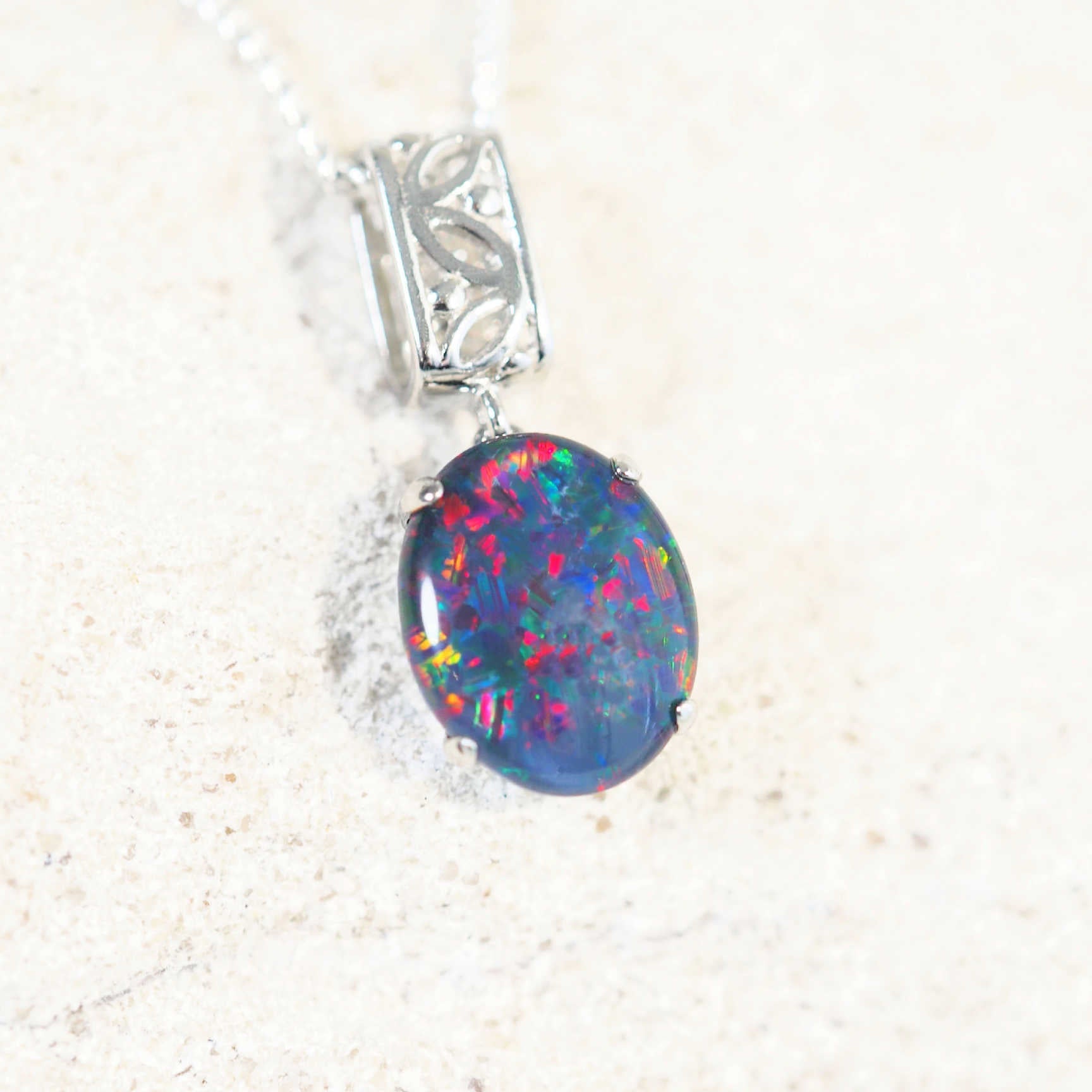 silver opal pendant with a colourful triplet opal