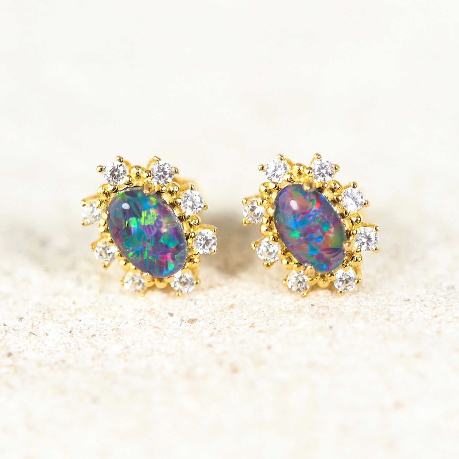 'Empress' gold-plated silver opal earrings featuring vibrant Australian triplet opals with a halo of eight sparkling diamantés, perfect for elegant occasions.