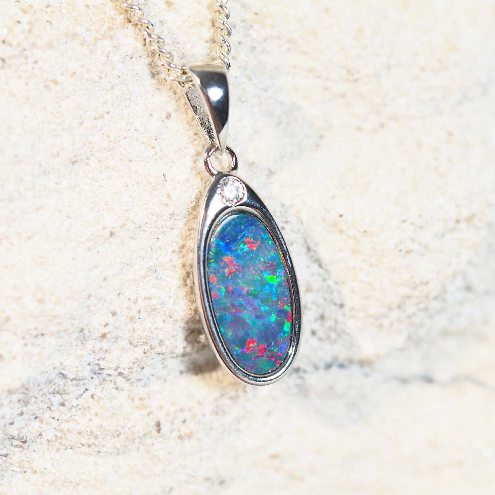 colourful australian opal pendant set in sterling silver with a crystal