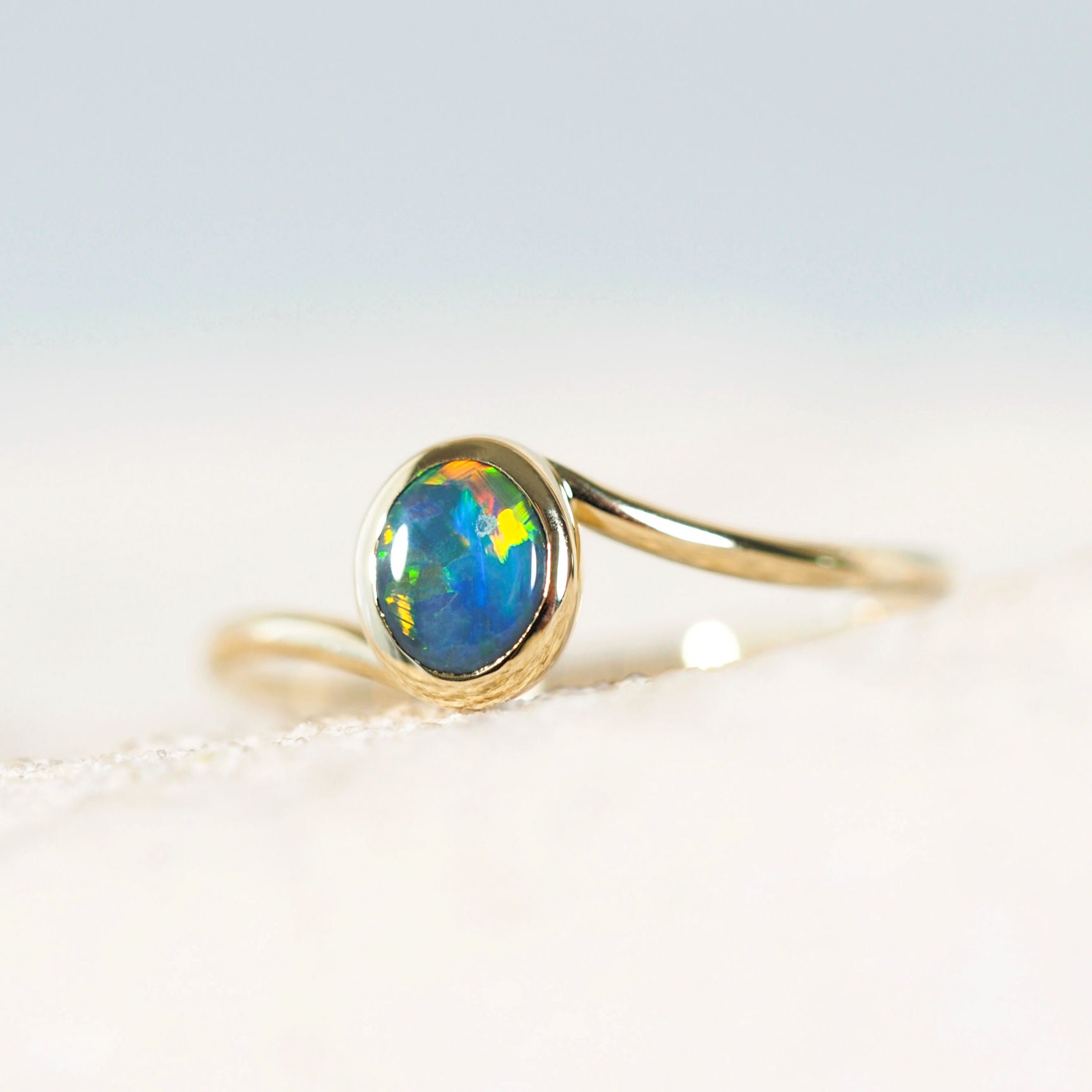 colourful black opal ring set in 14ct yellow gold