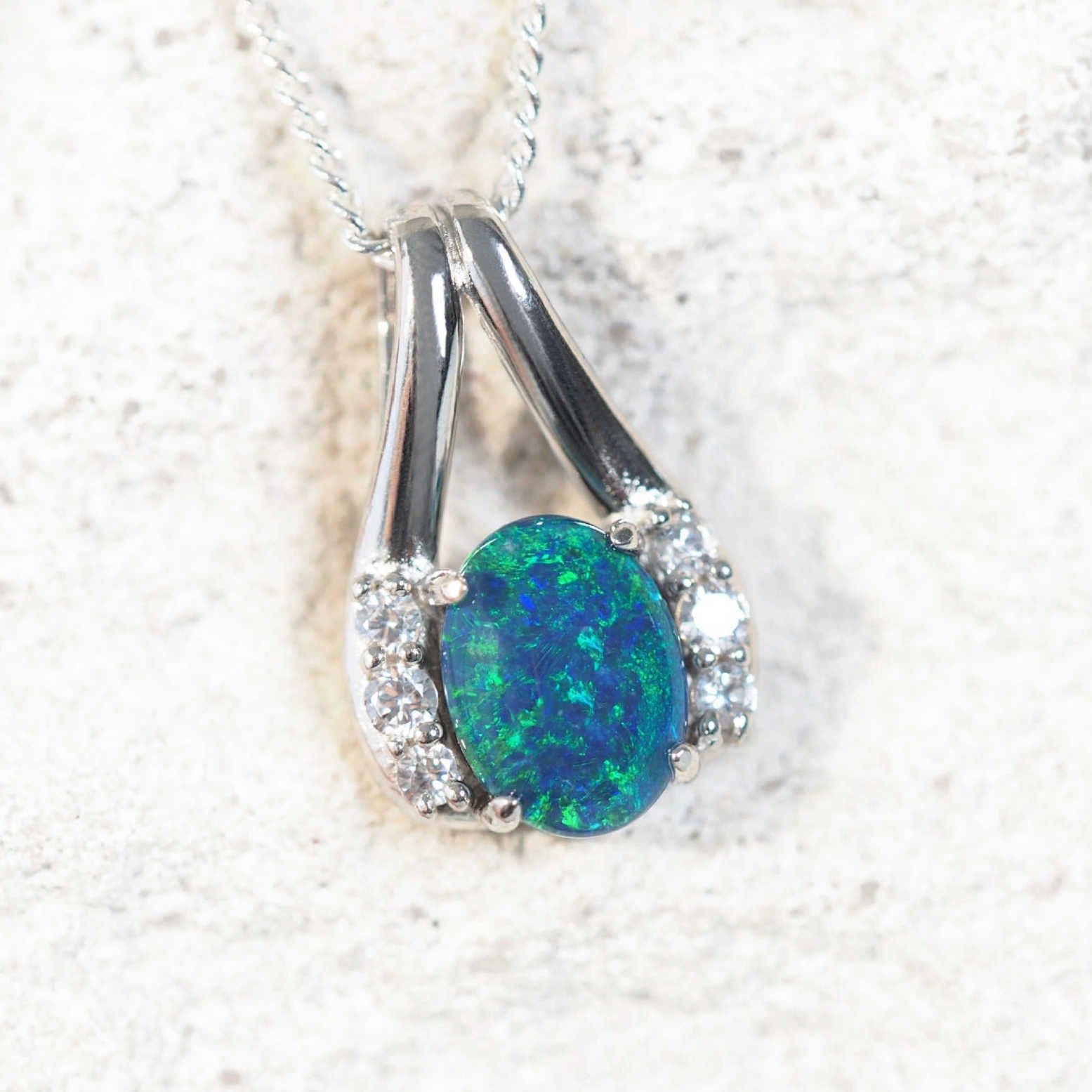 blue opal pendant set in sterling silver with six sparkling diamantes