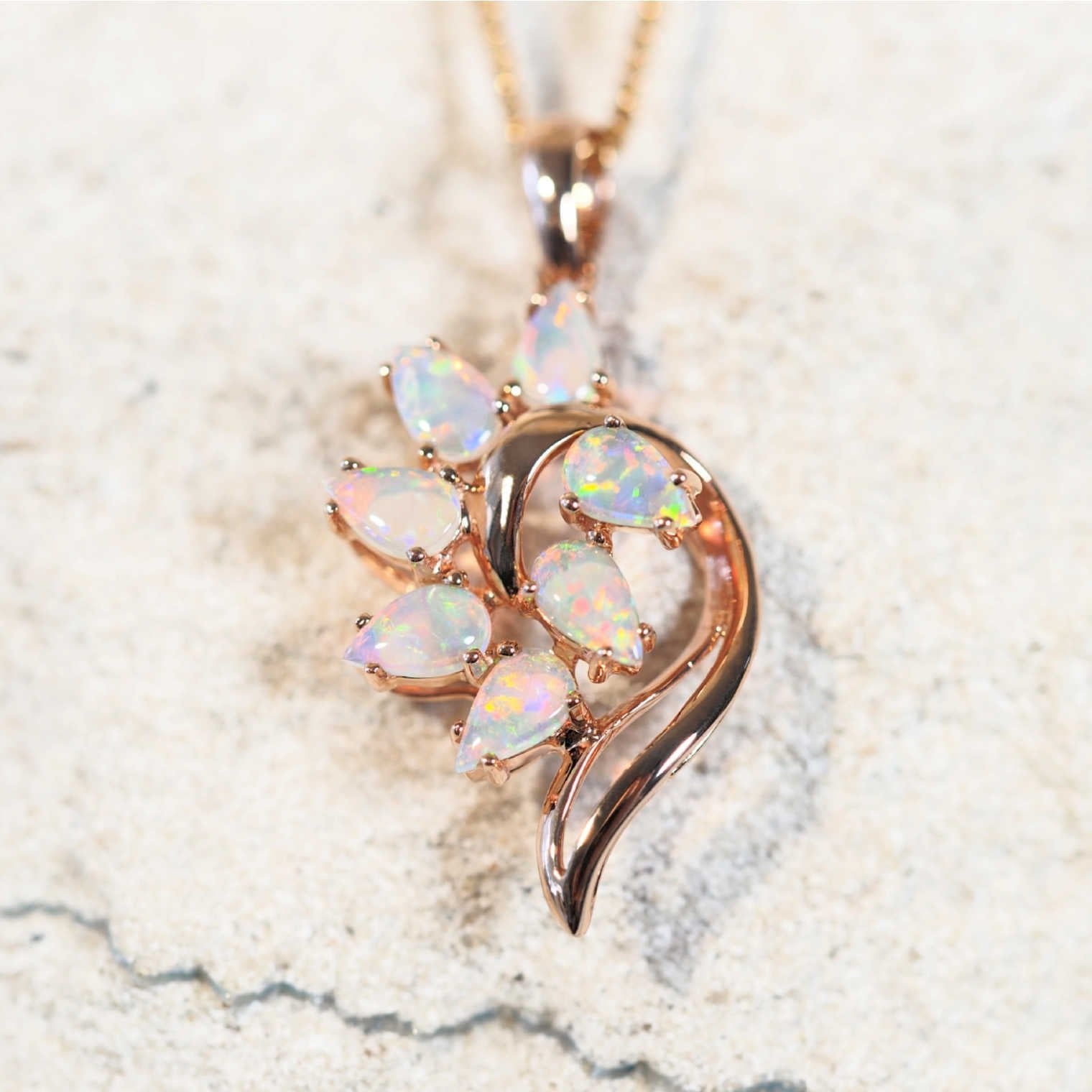 rose gold opal necklace set with seven multi-coloured stones