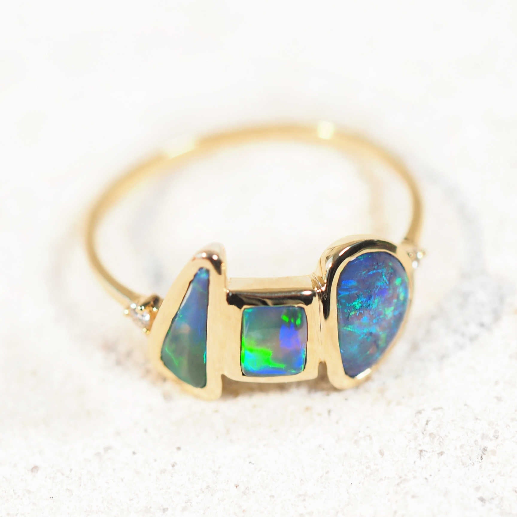 three black opals set into a 14ct gold opal ring