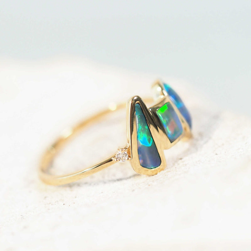 green and blue Lightning Ridge opal set in a trio gold ring