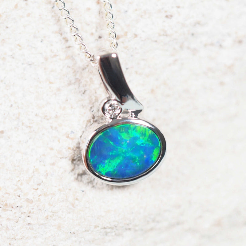 Elegant Marina opal necklace with a vibrant oval-shaped Australian doublet opal, 14ct white gold contemporary design, and a single sparkling white diamond