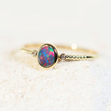 colourful black opal ring in 14ct yellow gold