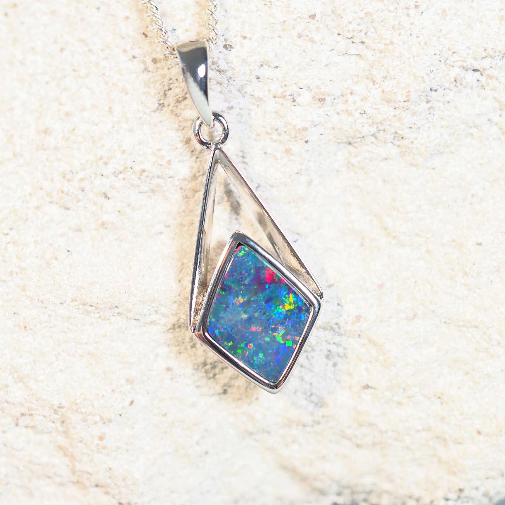 opal pendant set with a kite shaped, multi-colour doublet opal