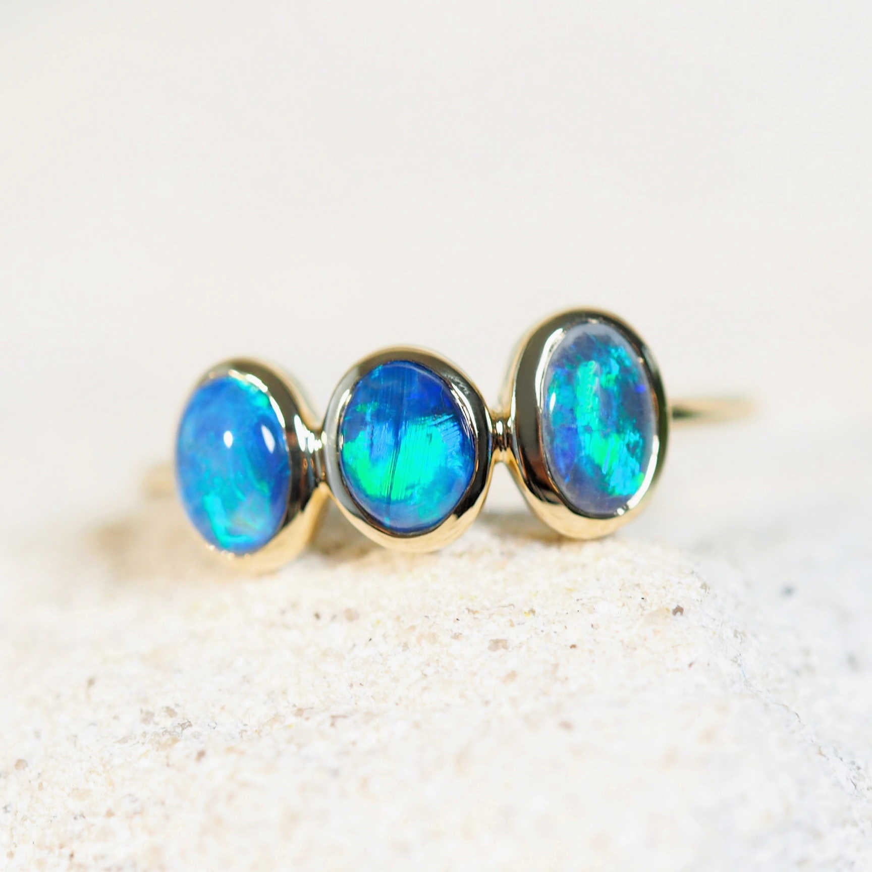 ocean coloured opals in a gold ring