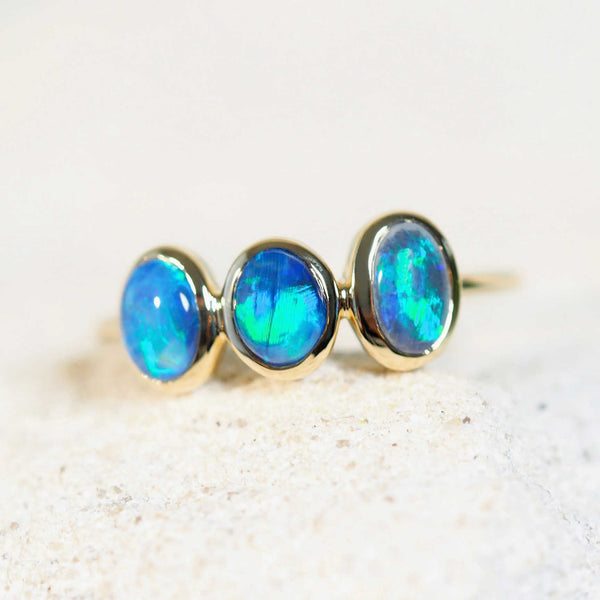 ocean coloured opals in a gold ring