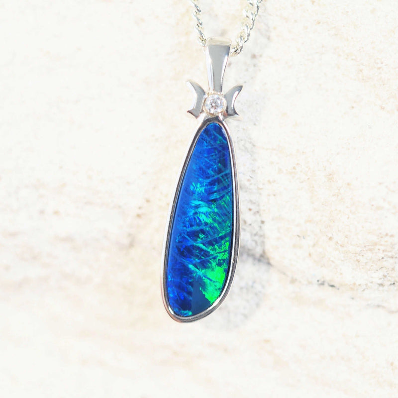 blue and green opal pendant with a bow design