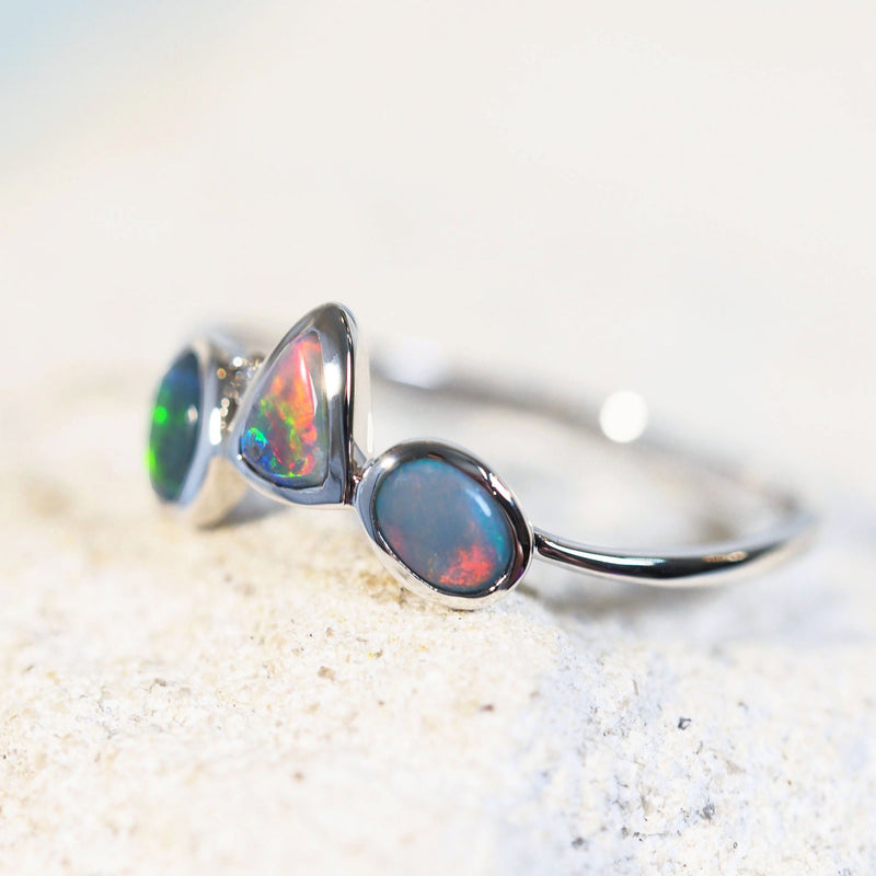 black opal ring set with a multi-colour opal