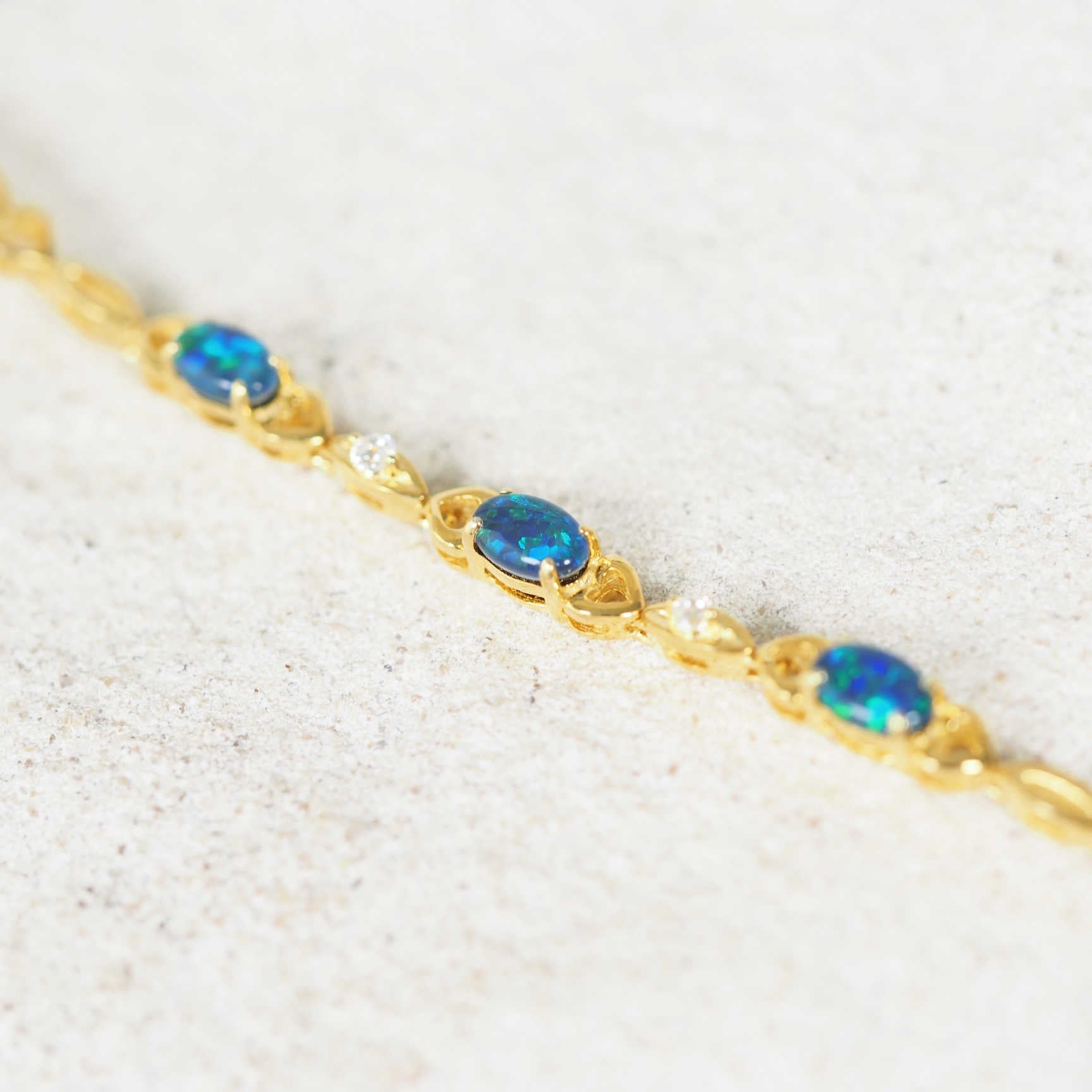 Gold-plated silver triplet opal bracelet featuring three stunning blue and green triplet opals and two diamantes