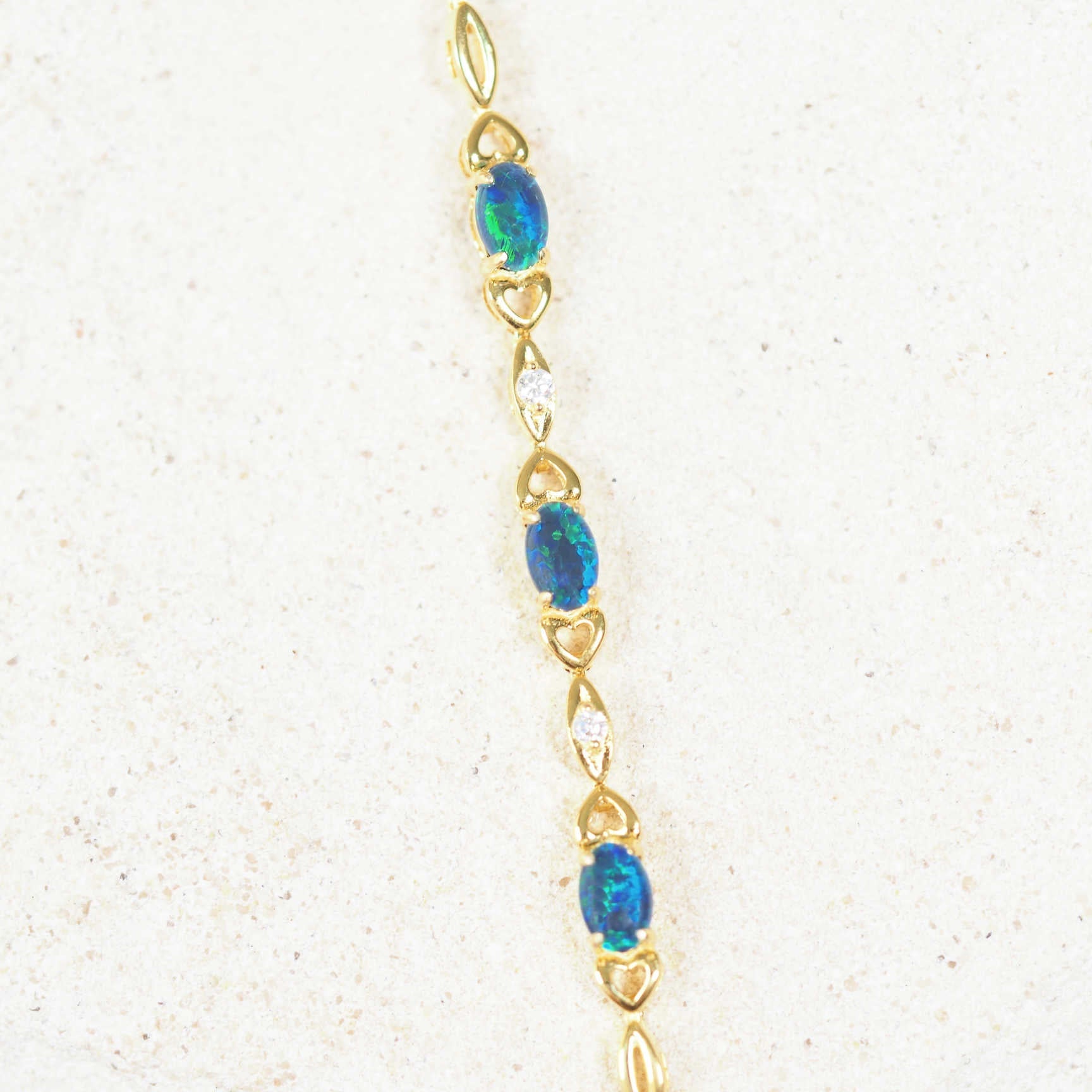 Gold-plated silver triplet opal bracelet featuring three blue and green opals