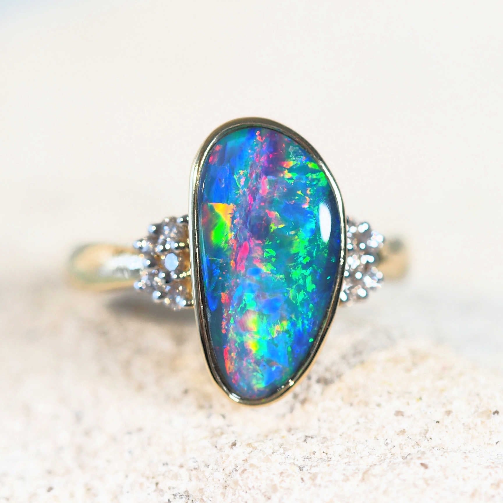 colourful australian opal ring set in gold with 10 diamonds