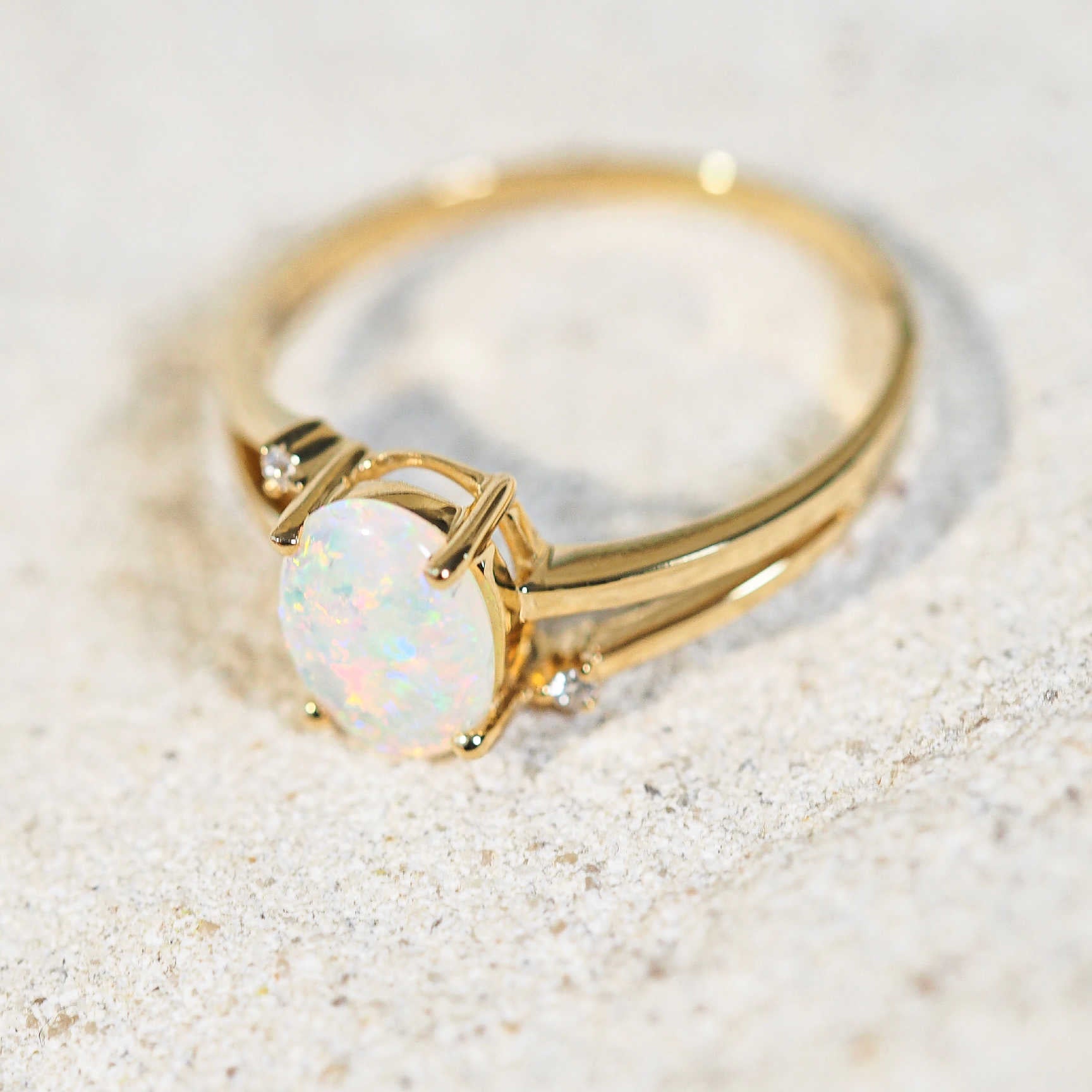 australian opal set in a yellow gold ring with two diamonds