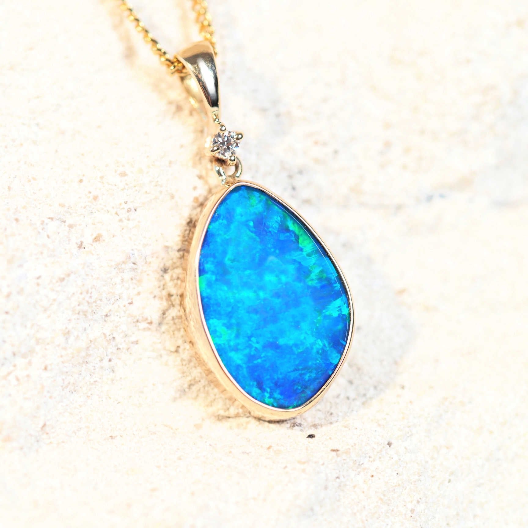 gold opal necklace with a blue stone