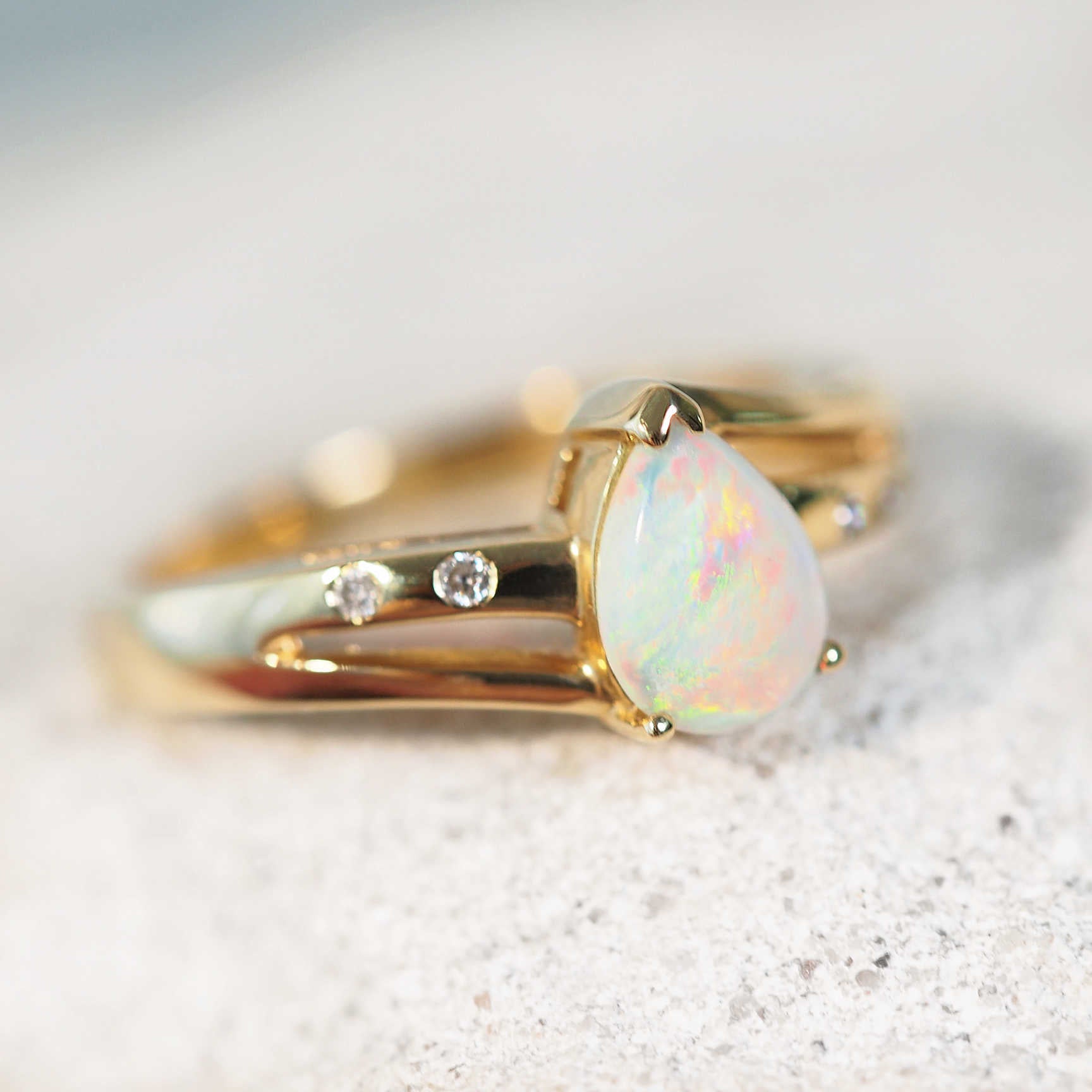 teardrop shape crystal opal set in 14ct yellow gold