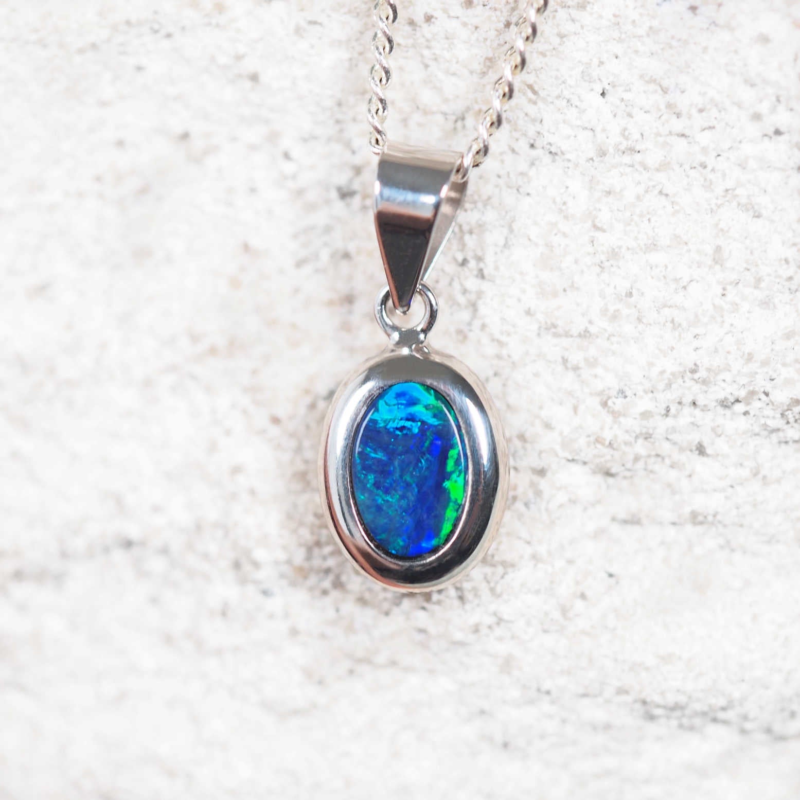 opal necklace set with a blue and green Australian gemstone in white gold